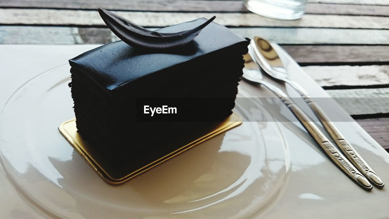 High angle view of fresh cake slice served in plate on table