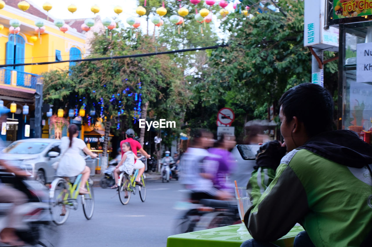 GROUP OF PEOPLE RIDING BICYCLE ON ROAD