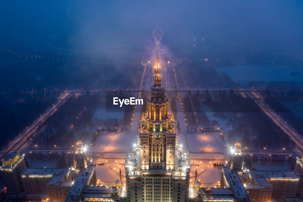 AERIAL VIEW OF ILLUMINATED BUILDINGS IN CITY