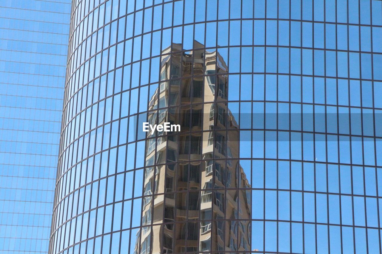 Low angle view of modern building with reflection