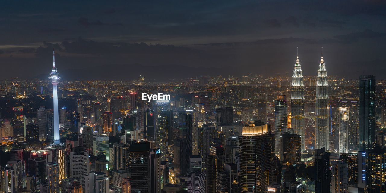 Aerial view of city lit up at night