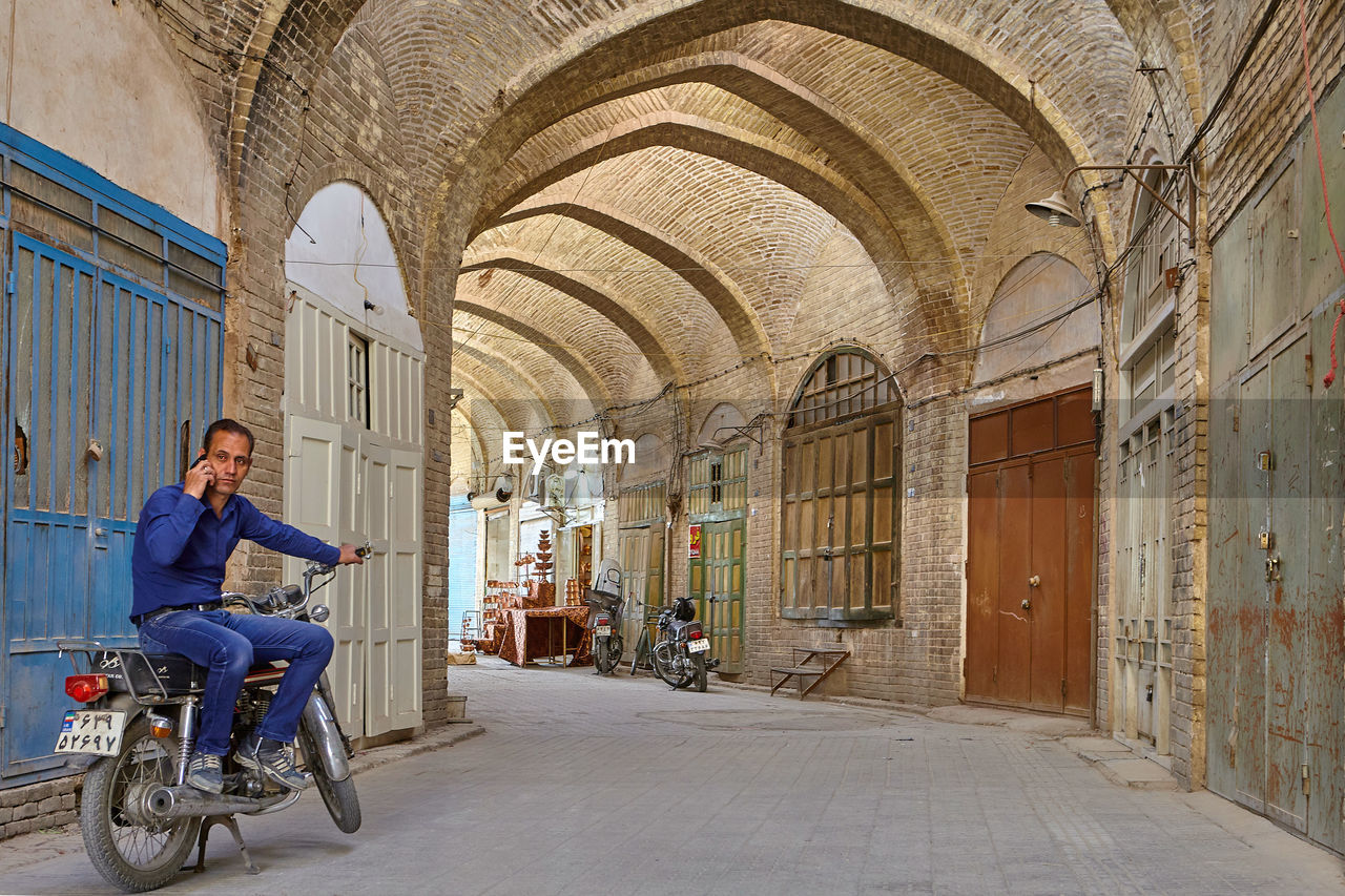 WOMAN RIDING BICYCLE IN BUILDING