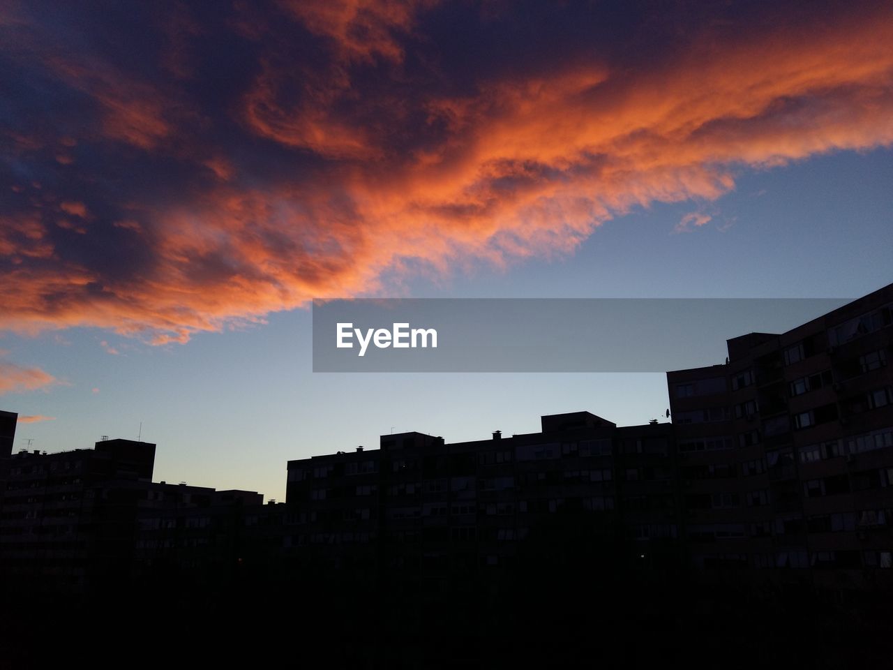 Low angle view of silhouette buildings against sky during sunset