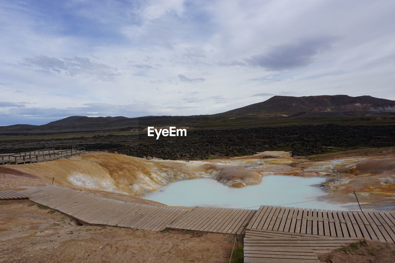 Scenic view of hot springs against sky