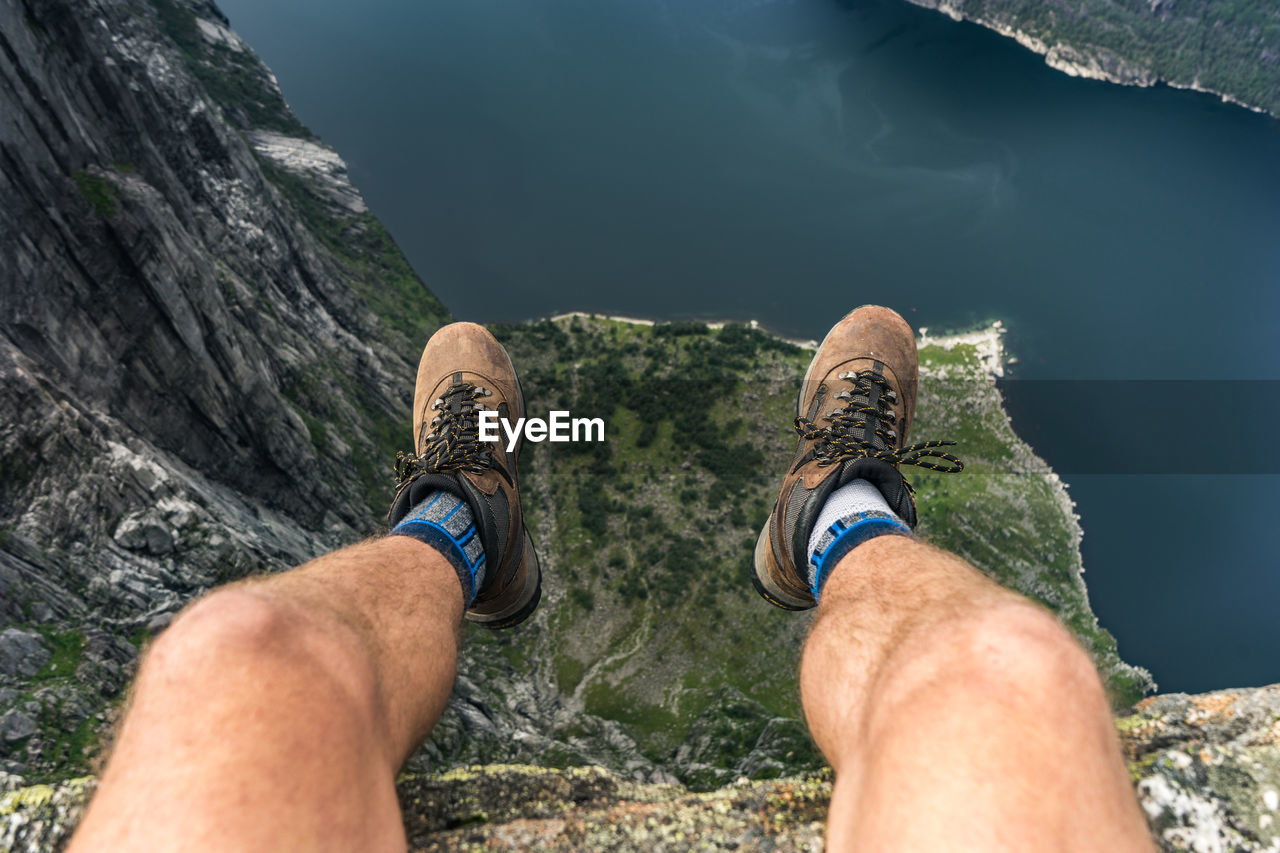 Low section of man against sea on cliff