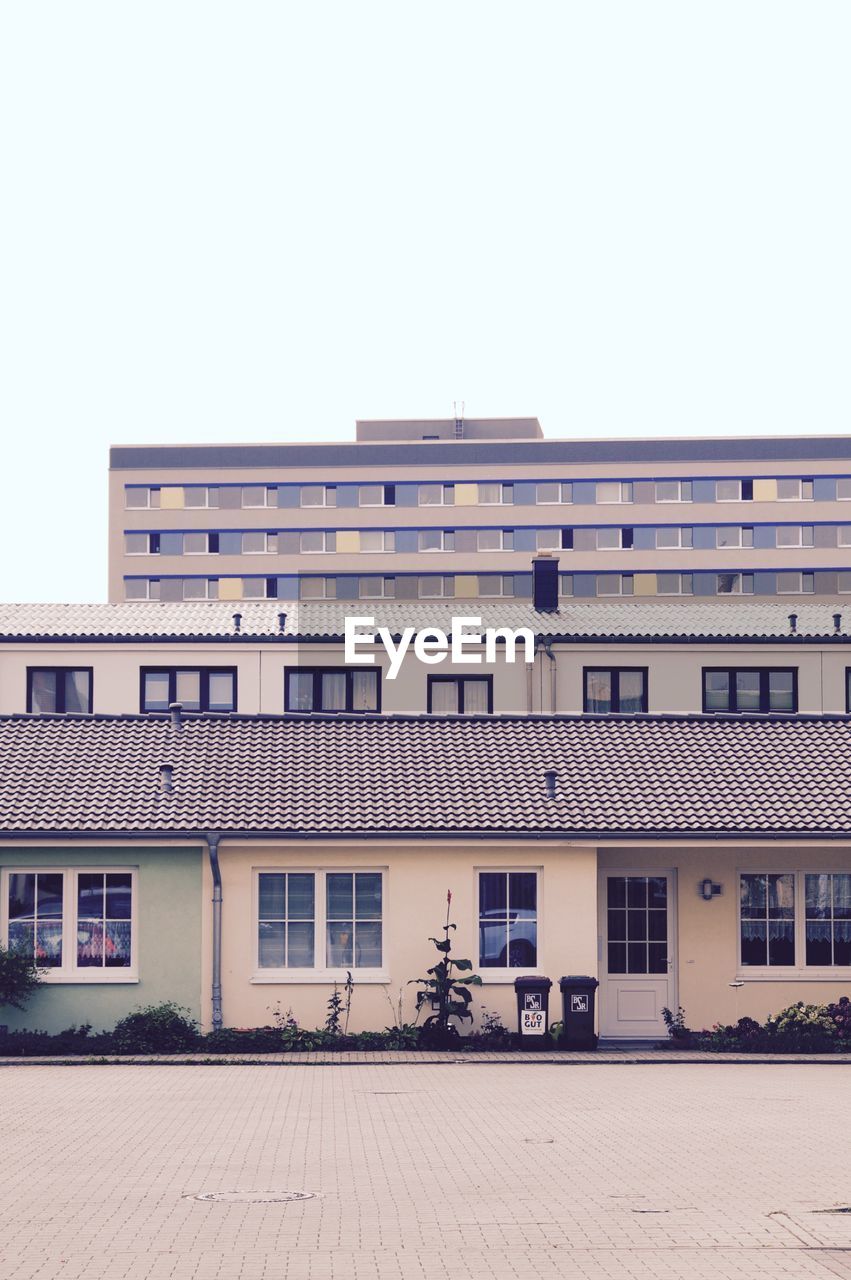 Street by buildings against sky