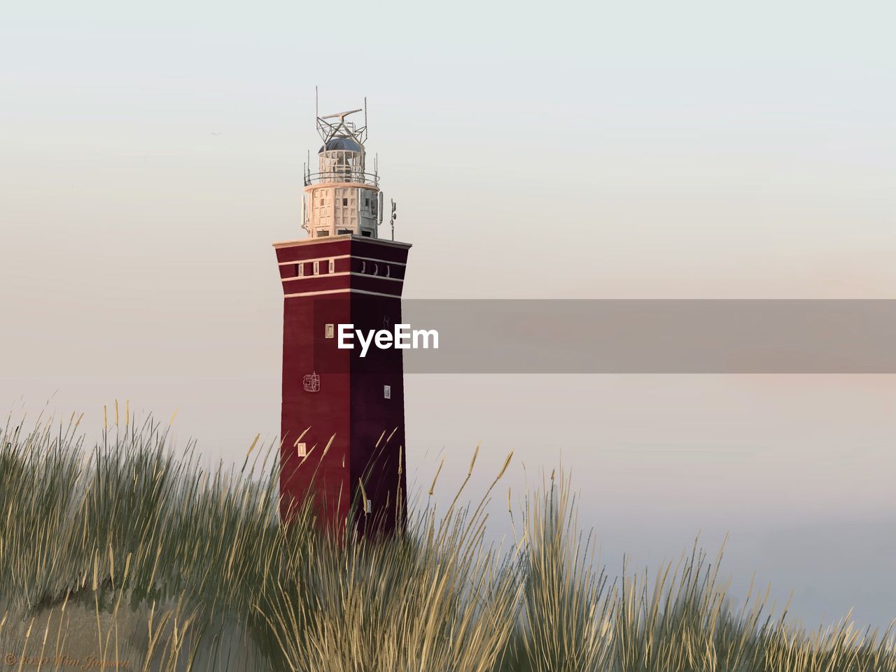 Lighthouse by sea against sky