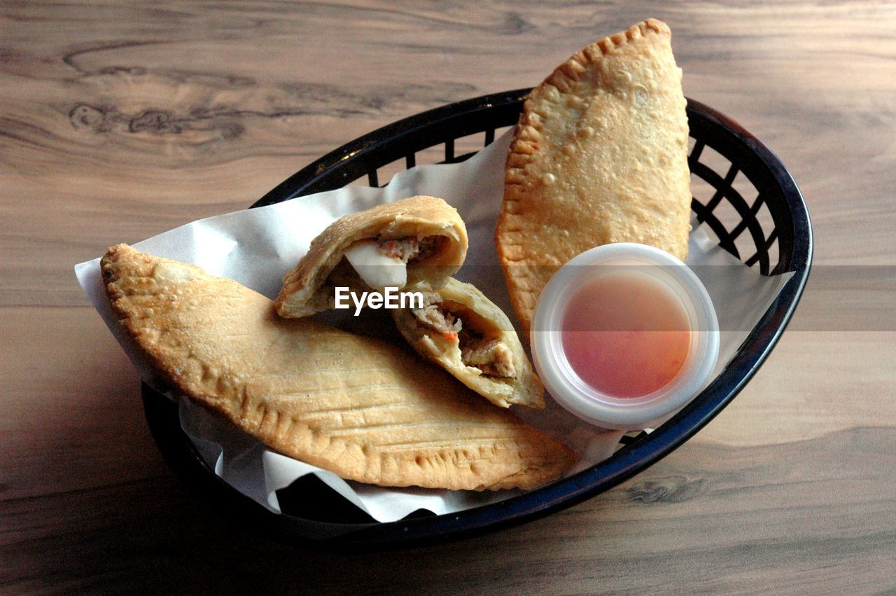 Close-up of breakfast served in basket on wooden table