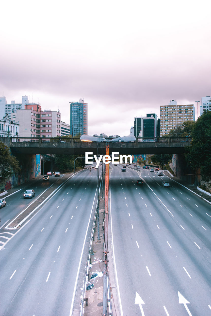 High angle view of highway by buildings against sky