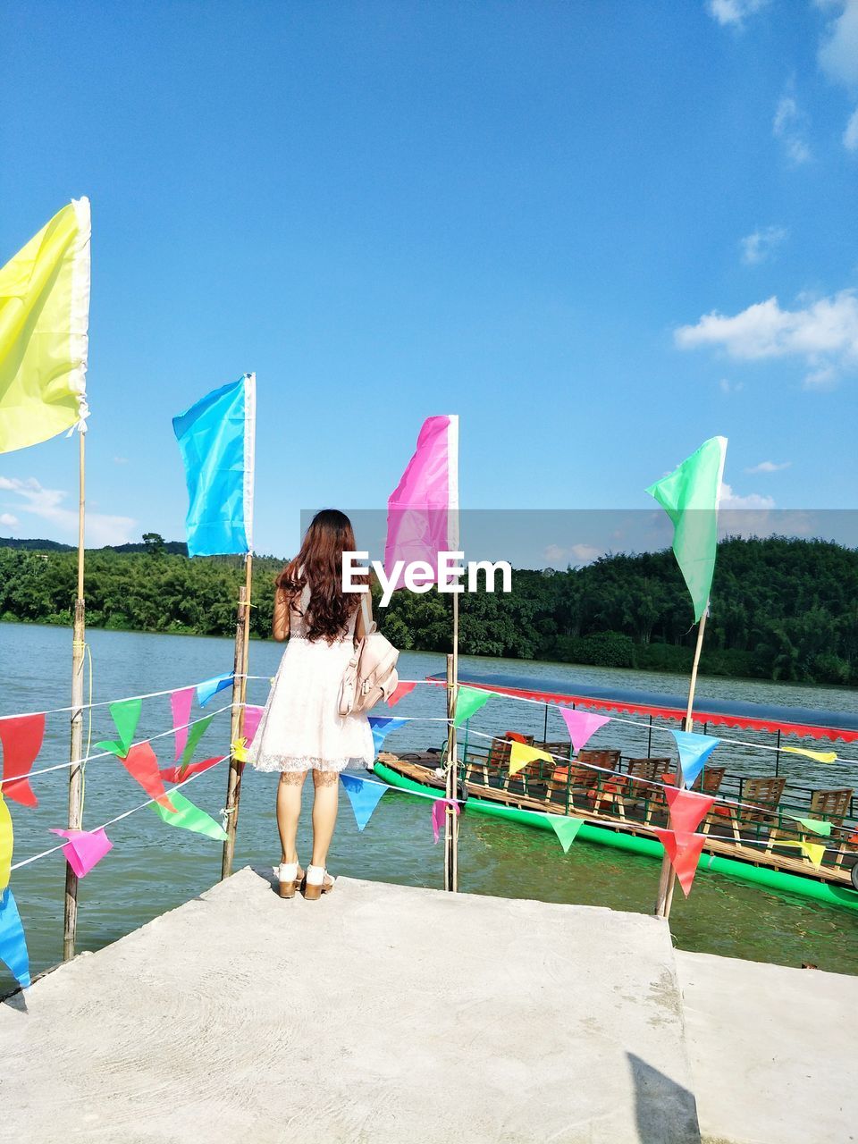 Woman standing at beach against sky