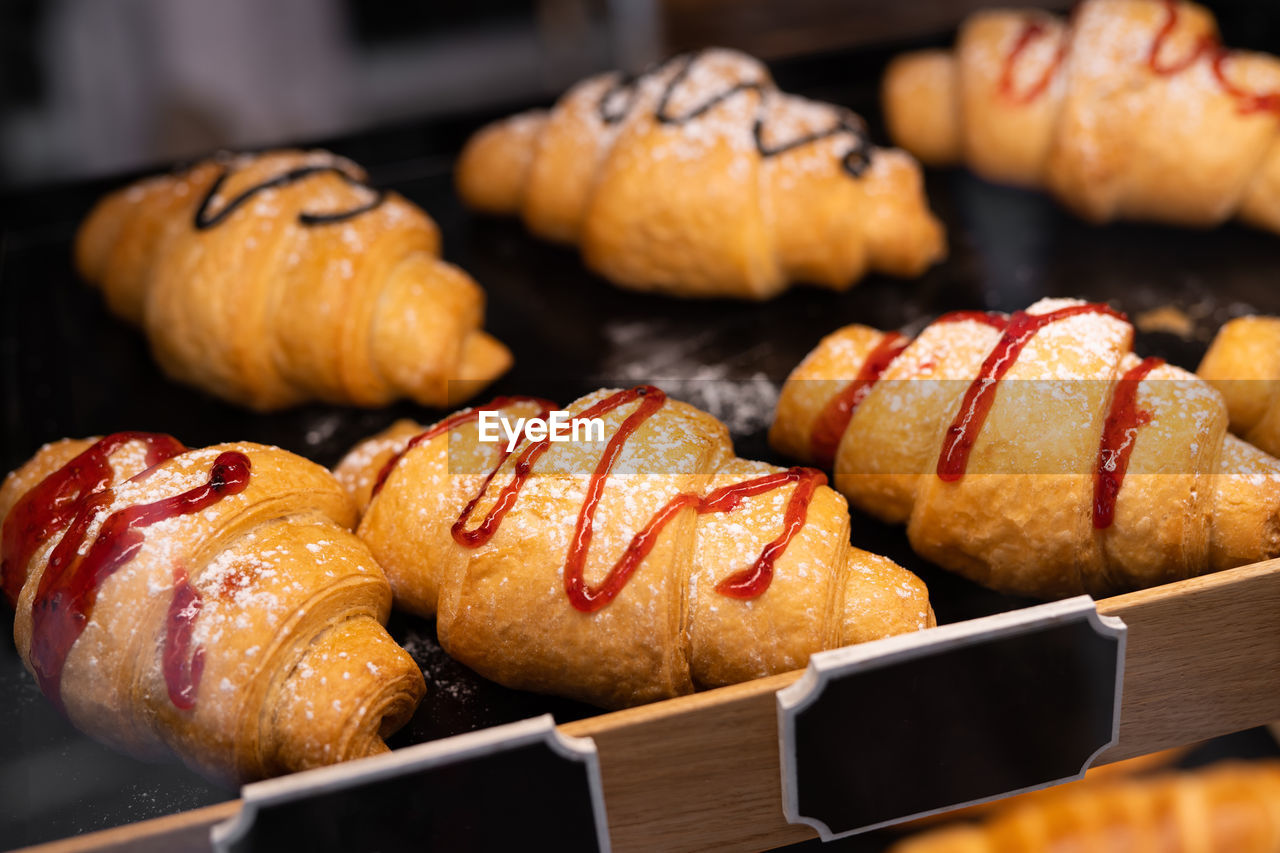 Delicious croissants with filling in the shop window