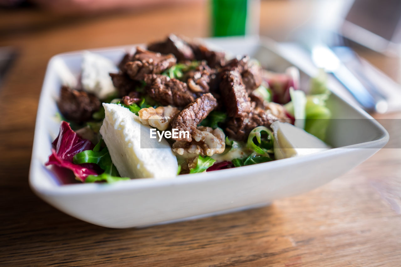 Close-up of beef cheese salad in bowl on table
