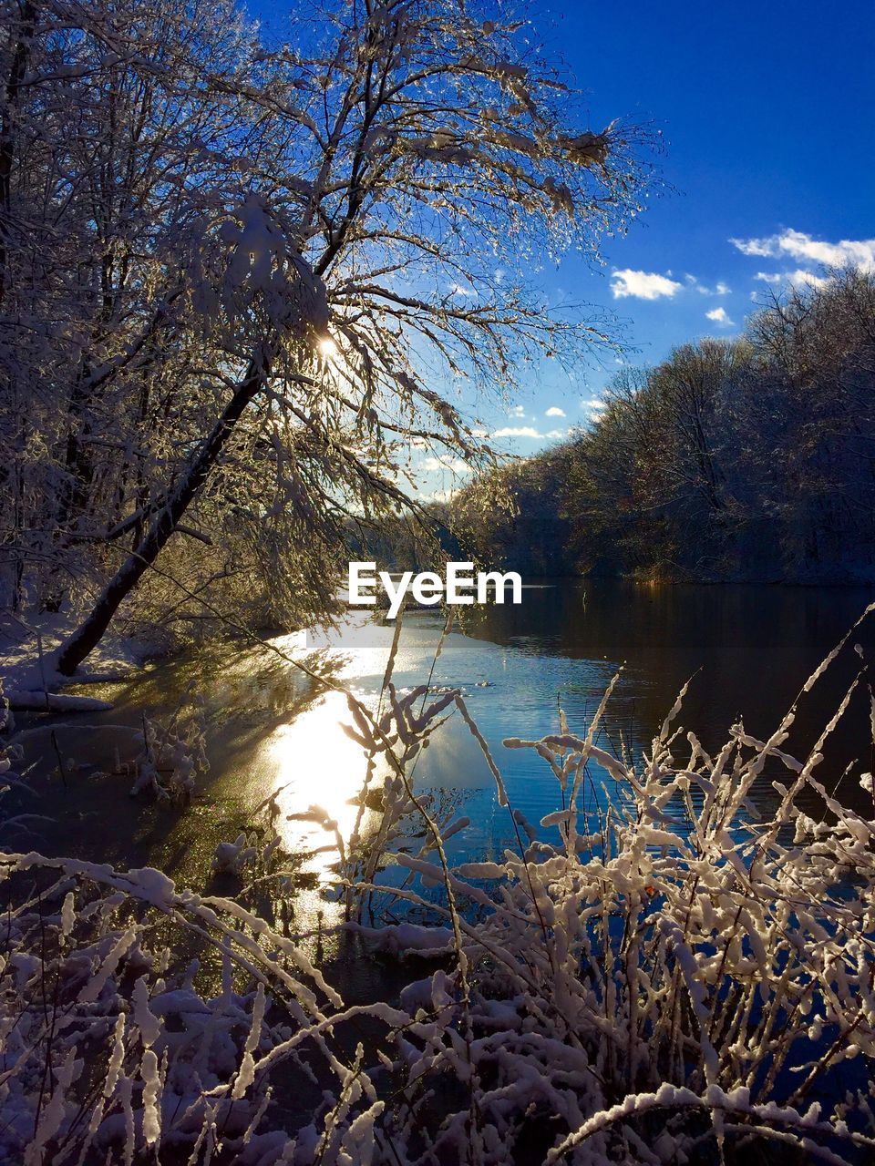 Scenic view of calm lake against cloudy sky