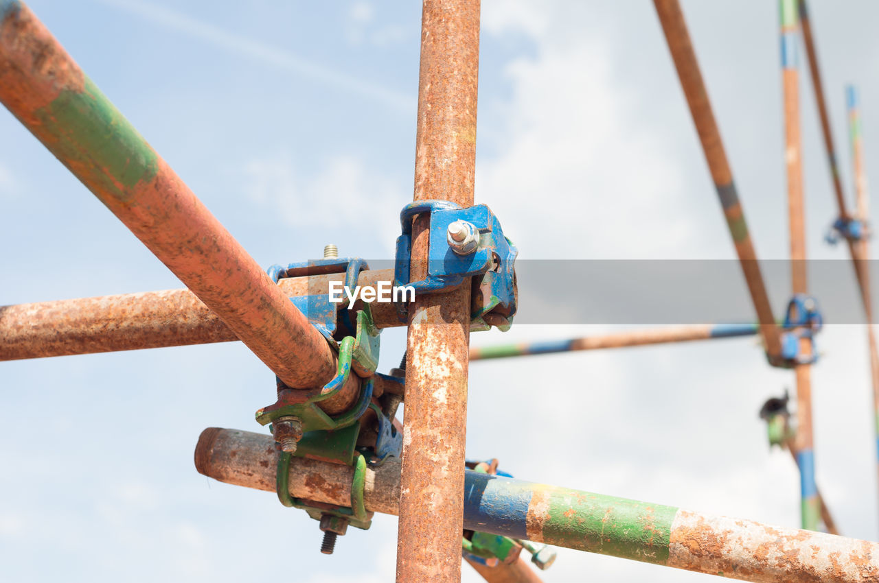 Close-up of rusty metal against sky