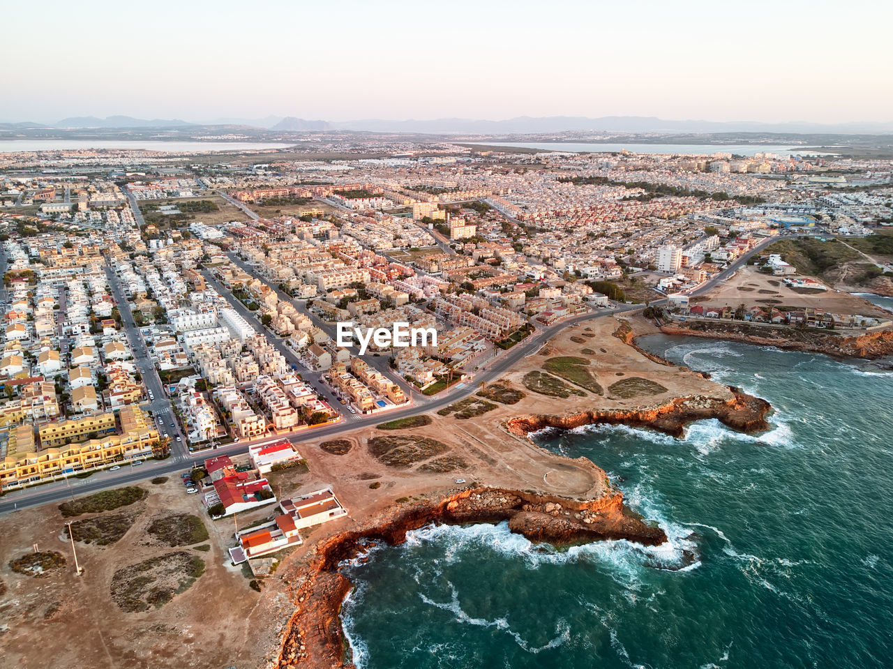 Aerial view of buildings by sea in city