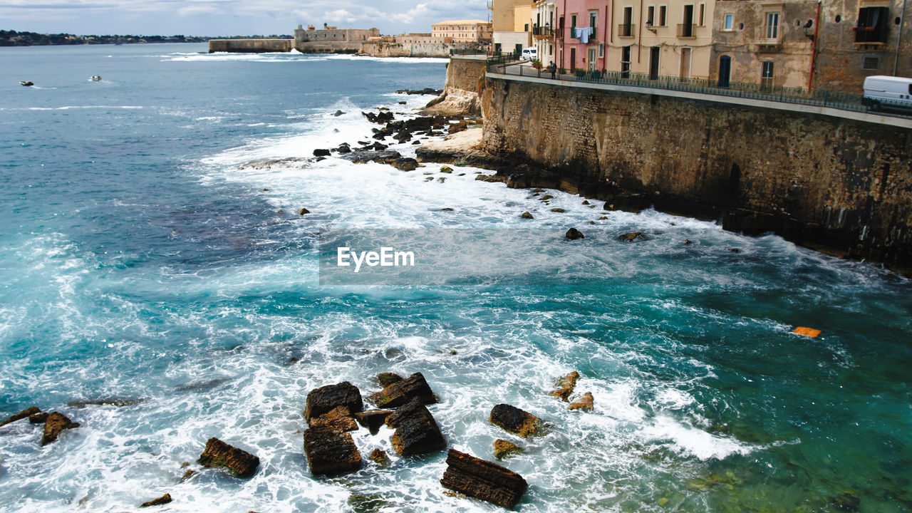 Ortigia siracusa island with waves of sea on the rocks