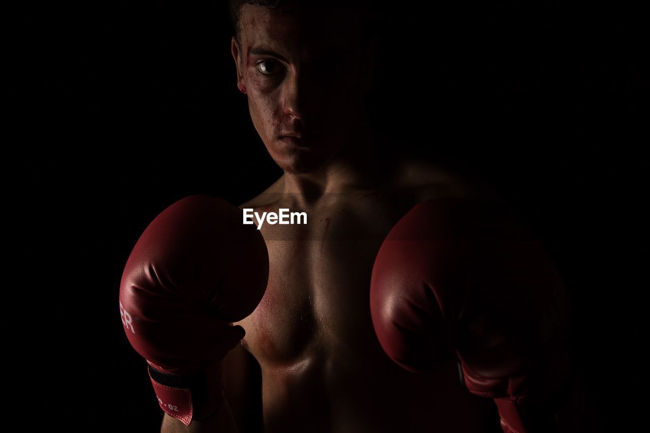 Portrait of man wearing boxing gloves
