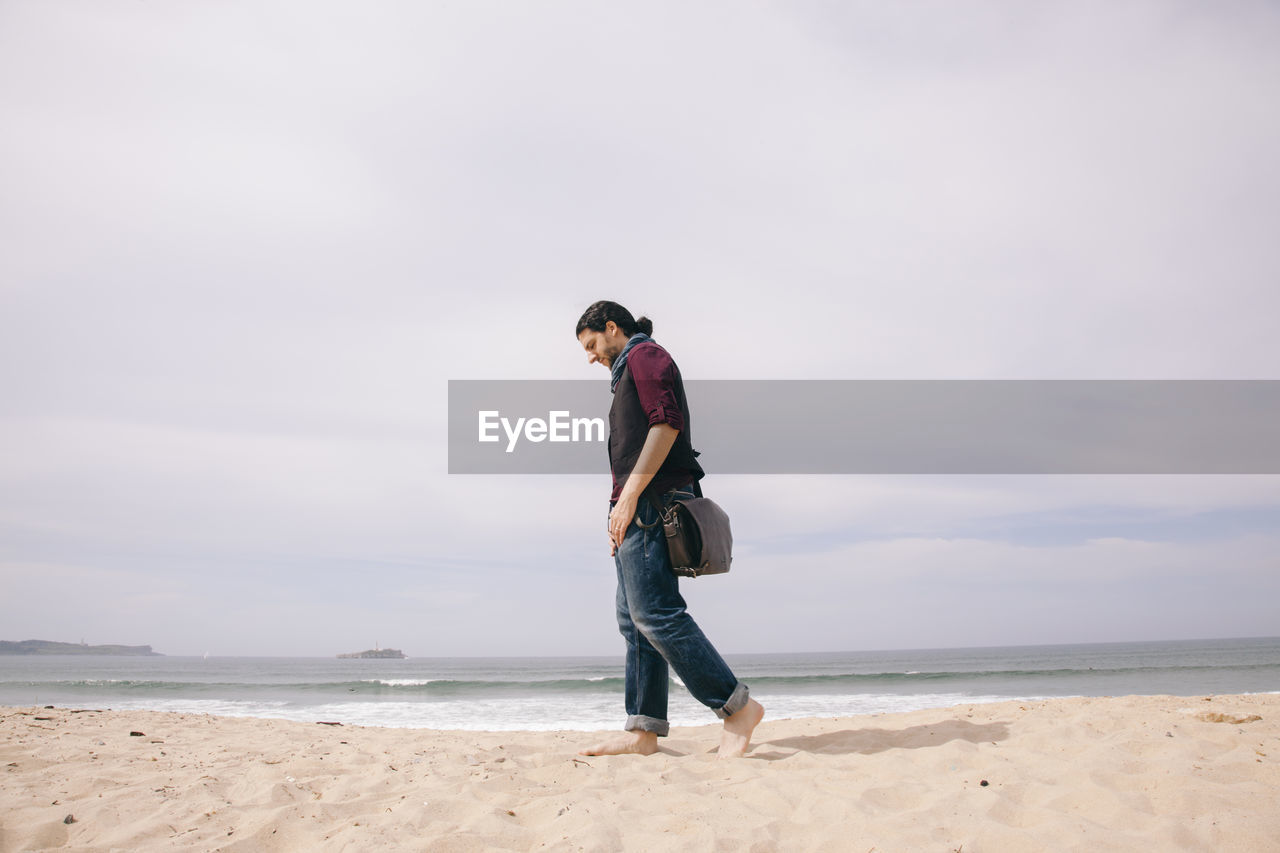 Full length of man walking at beach