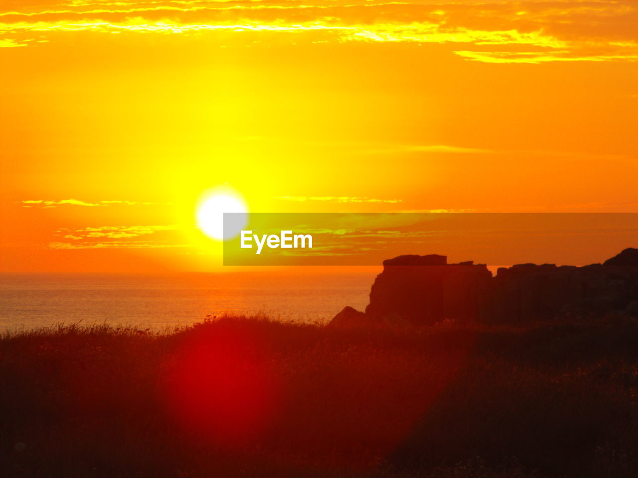 SCENIC VIEW OF SUNSET OVER SILHOUETTE LANDSCAPE