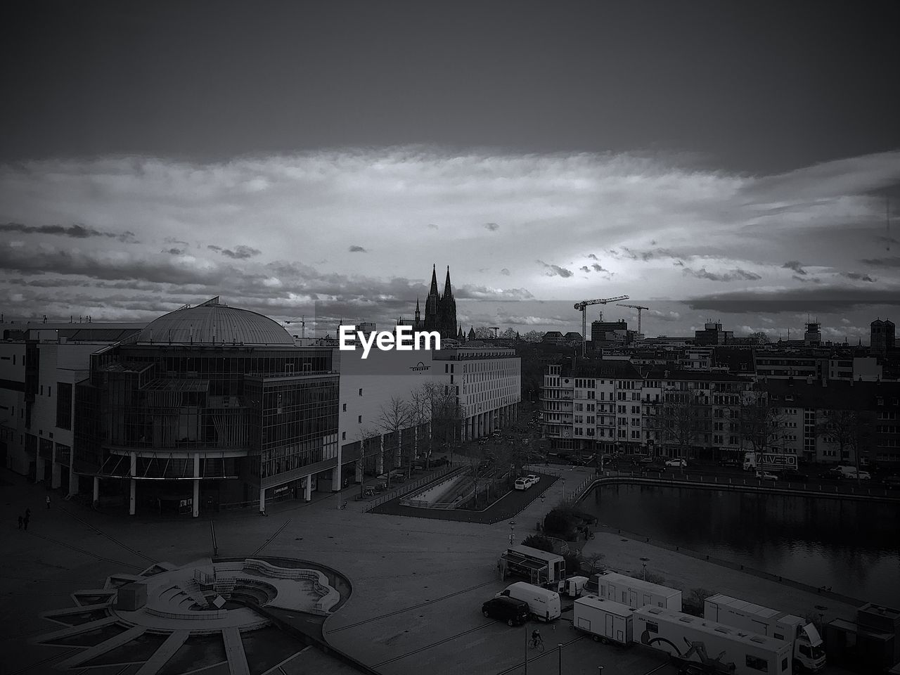 HIGH ANGLE VIEW OF CITY BUILDINGS AGAINST CLOUDY SKY