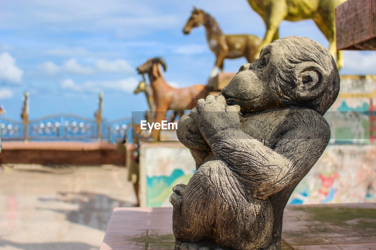 CLOSE-UP OF STATUE AGAINST SKY IN BACKGROUND