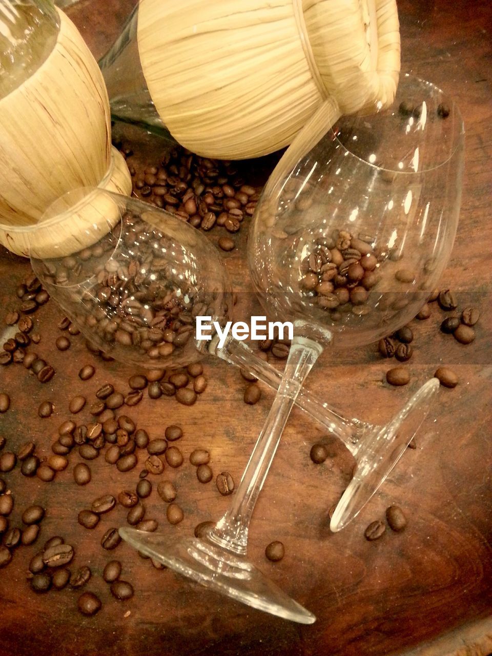 High angle view of coffee beans and wineglass on table