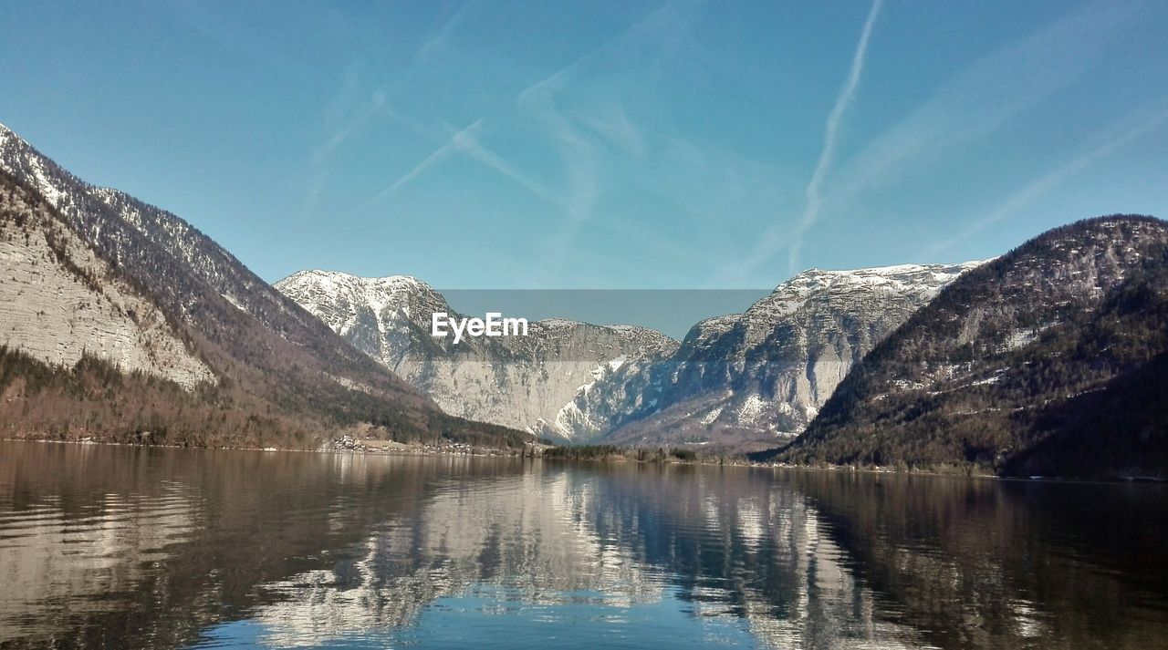 Scenic view of lake and snowcapped mountains against sky