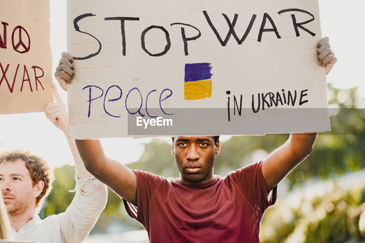 Black man with a banner during the russian war protest.