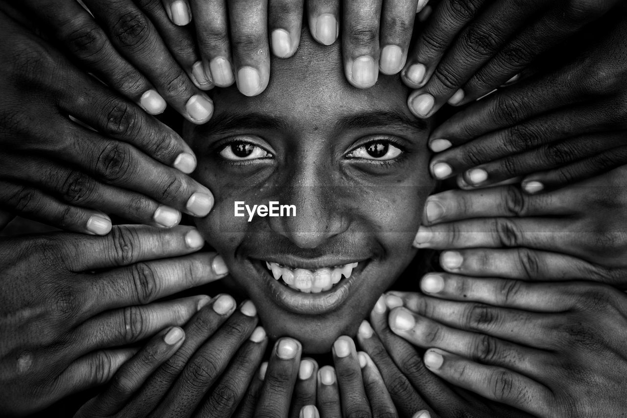 Close-up portrait of smiling man with hands