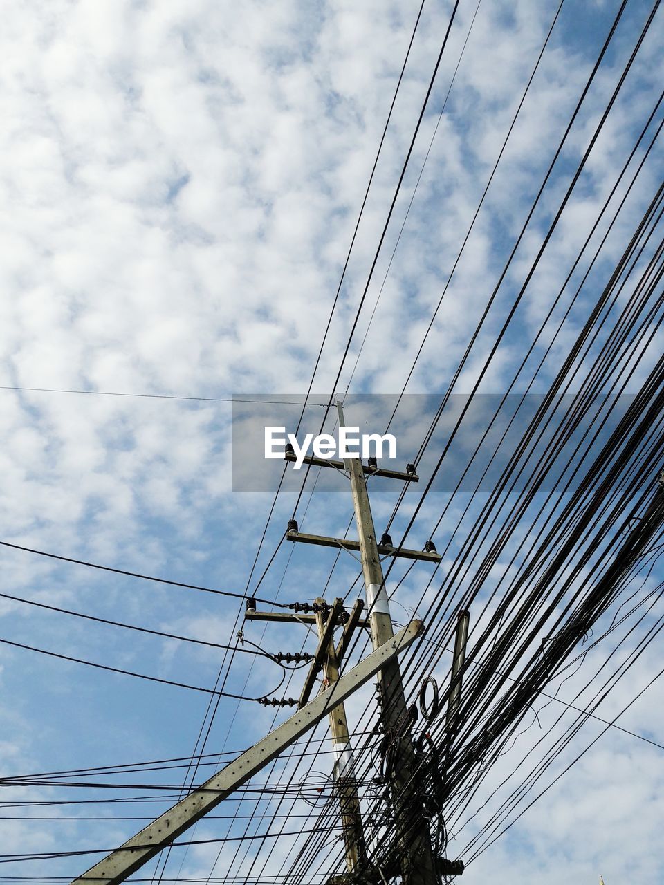 Low angle view of electricity pylon against sky