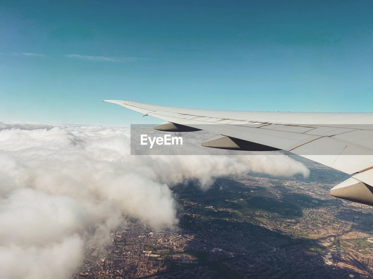 Aerial view of aircraft wing against sky