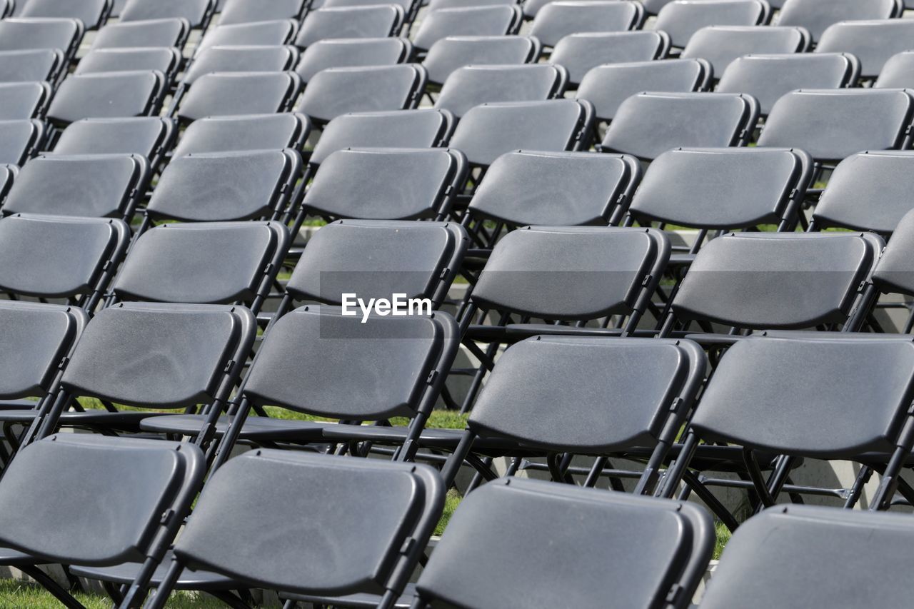 Full frame shot of empty chairs arranged on field