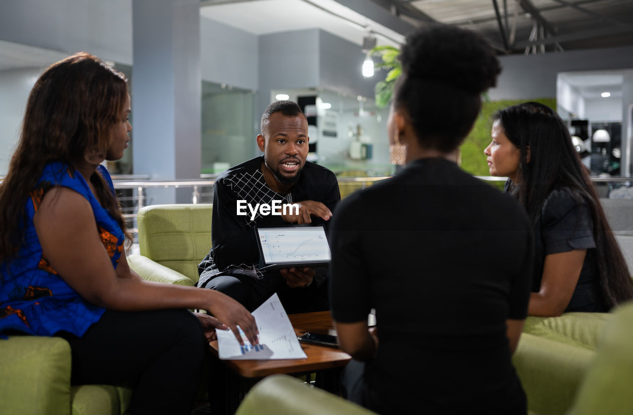 Business person having discussion while sitting in office