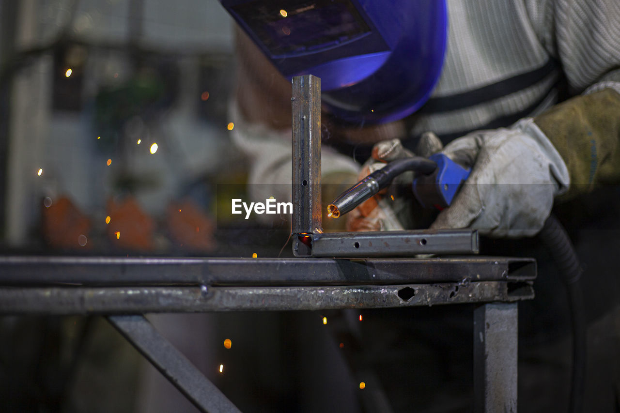 Man working on metal bridge