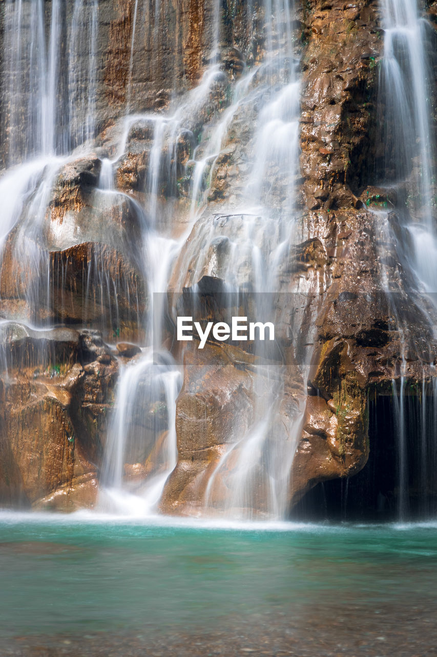 Smooth long exposure of waterfall. creamy beautiful waterfall falling off a cliff in the mountas.