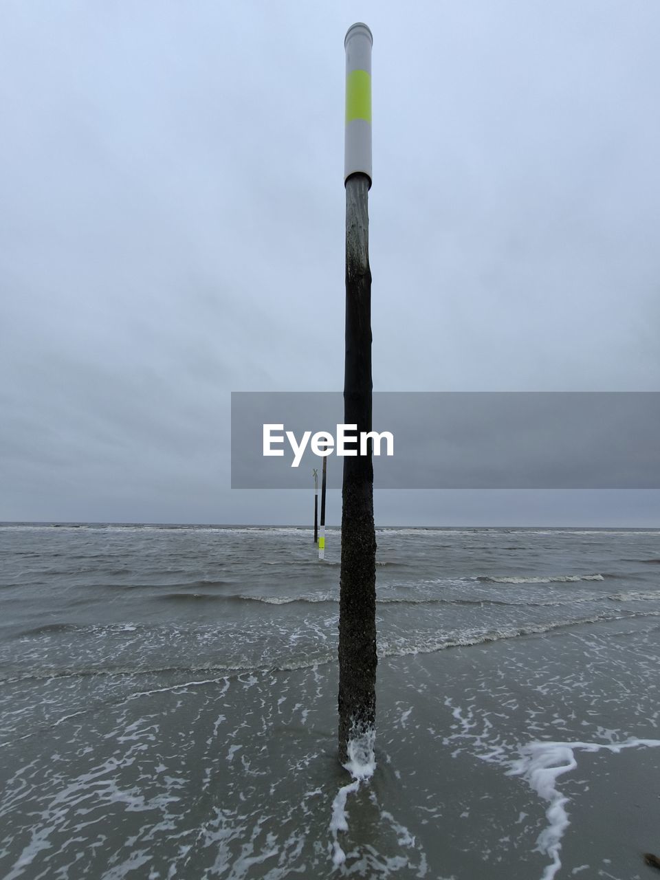 water, wind, sea, sky, ocean, nature, wave, coast, shore, beauty in nature, no people, scenics - nature, tower, land, day, pole, post, environment, outdoors, wooden post, tranquility, beach, vehicle, cloud, horizon, tranquil scene, non-urban scene, wind wave, wood, horizon over water