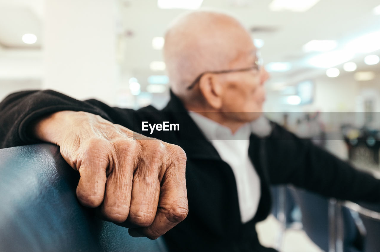 Close-up of senior businessman sitting on seat