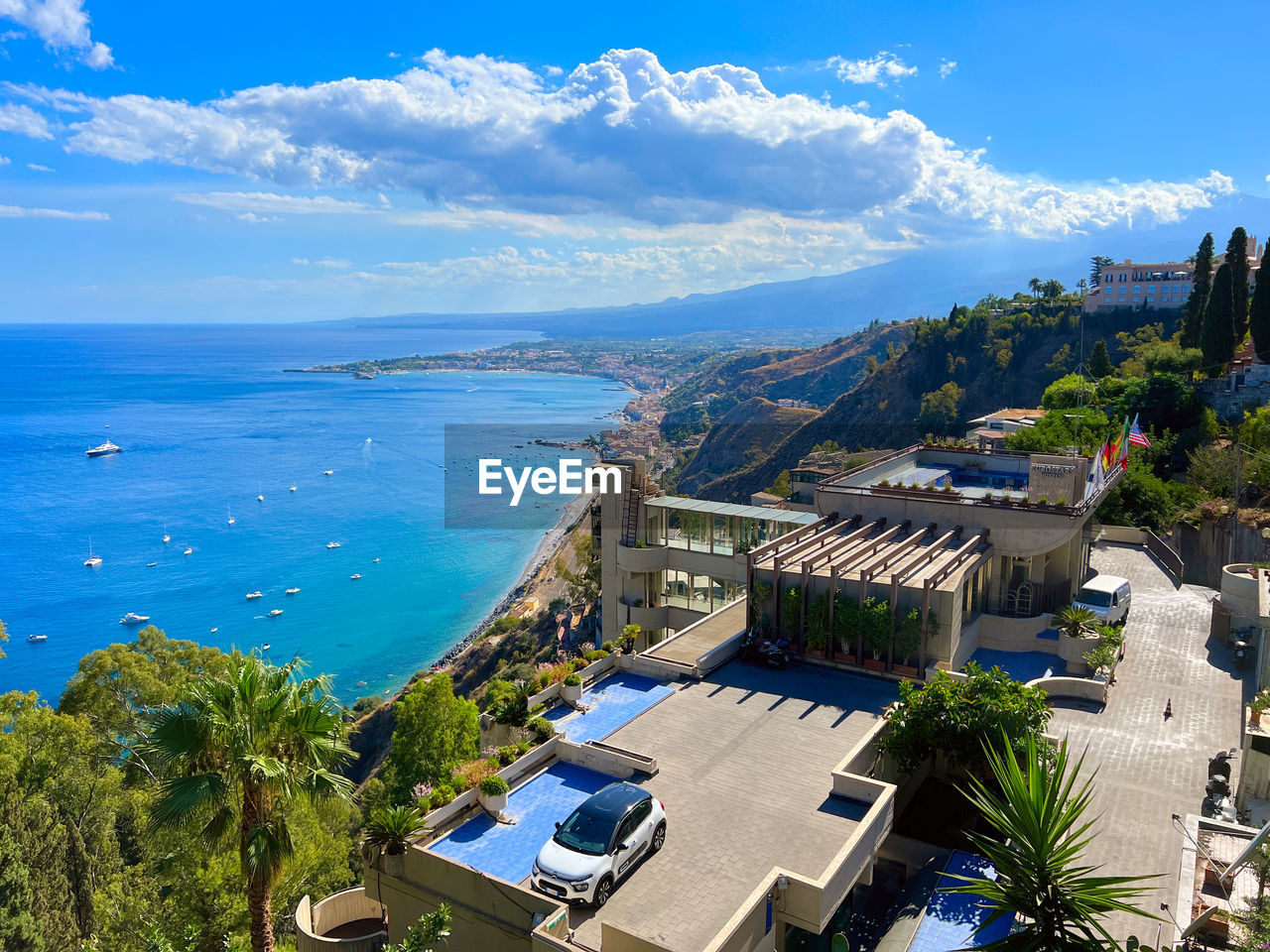 High angle view of townscape by sea against sky