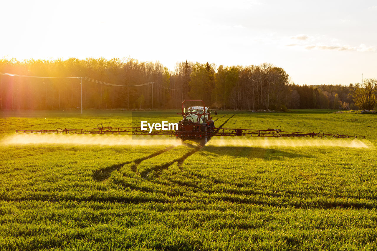 Tractor spraying field