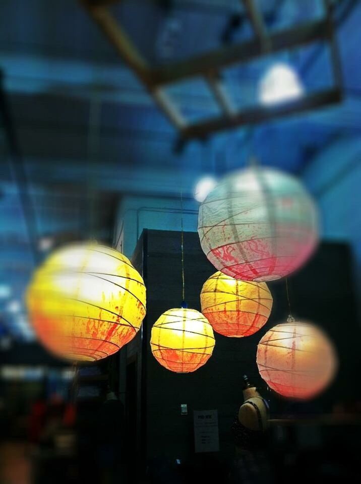 LOW ANGLE VIEW OF ILLUMINATED LIGHT BULBS HANGING ON CEILING