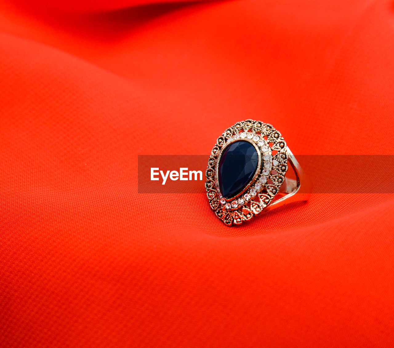 Picture of a fashion ring. red background,