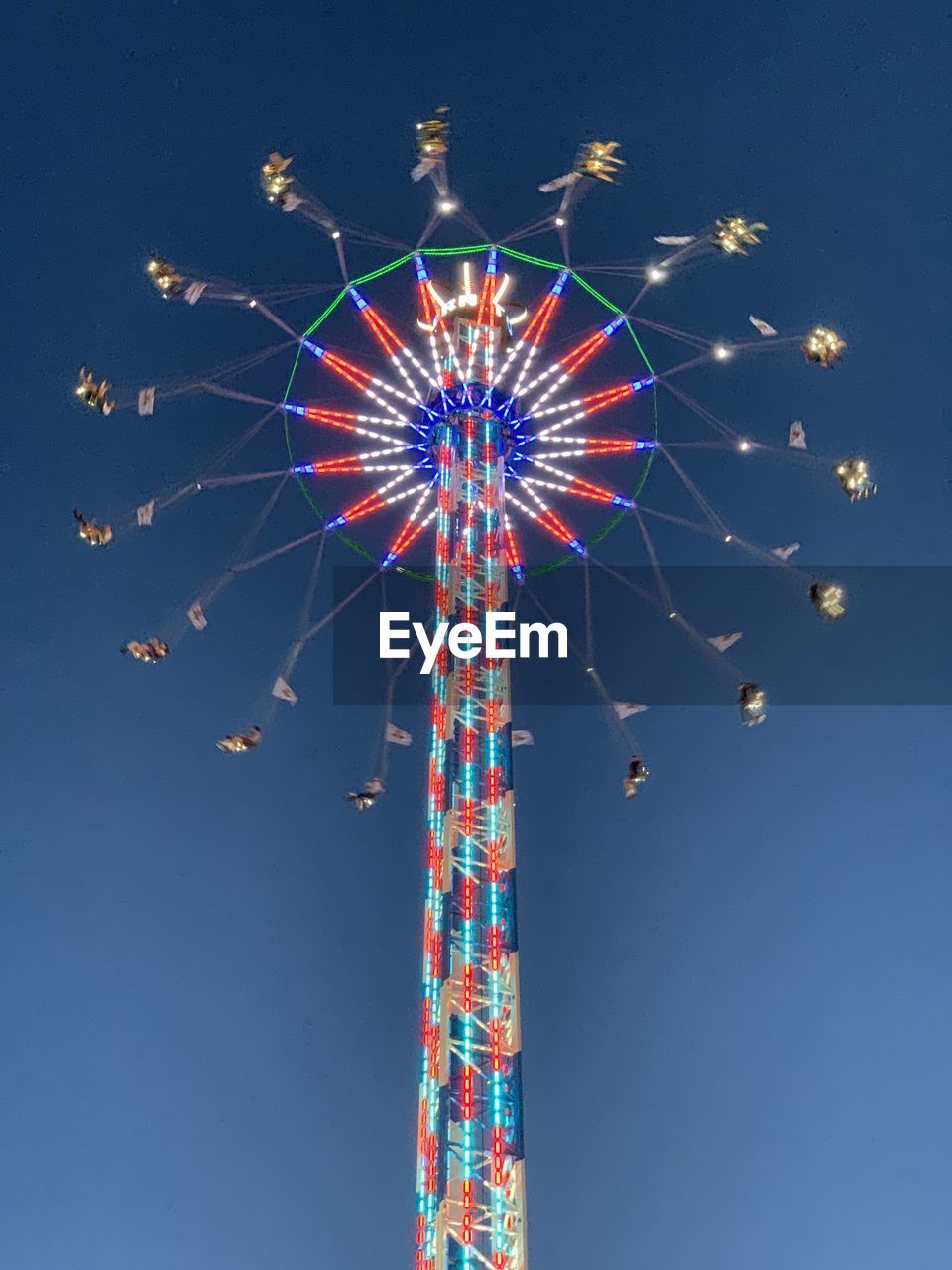 Low angle view of illuminated ferris wheel against sky at night