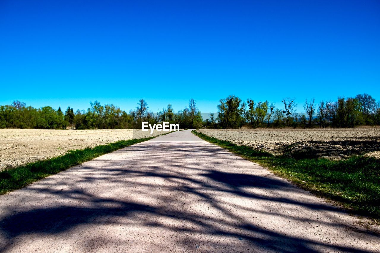 Empty road along countryside landscape