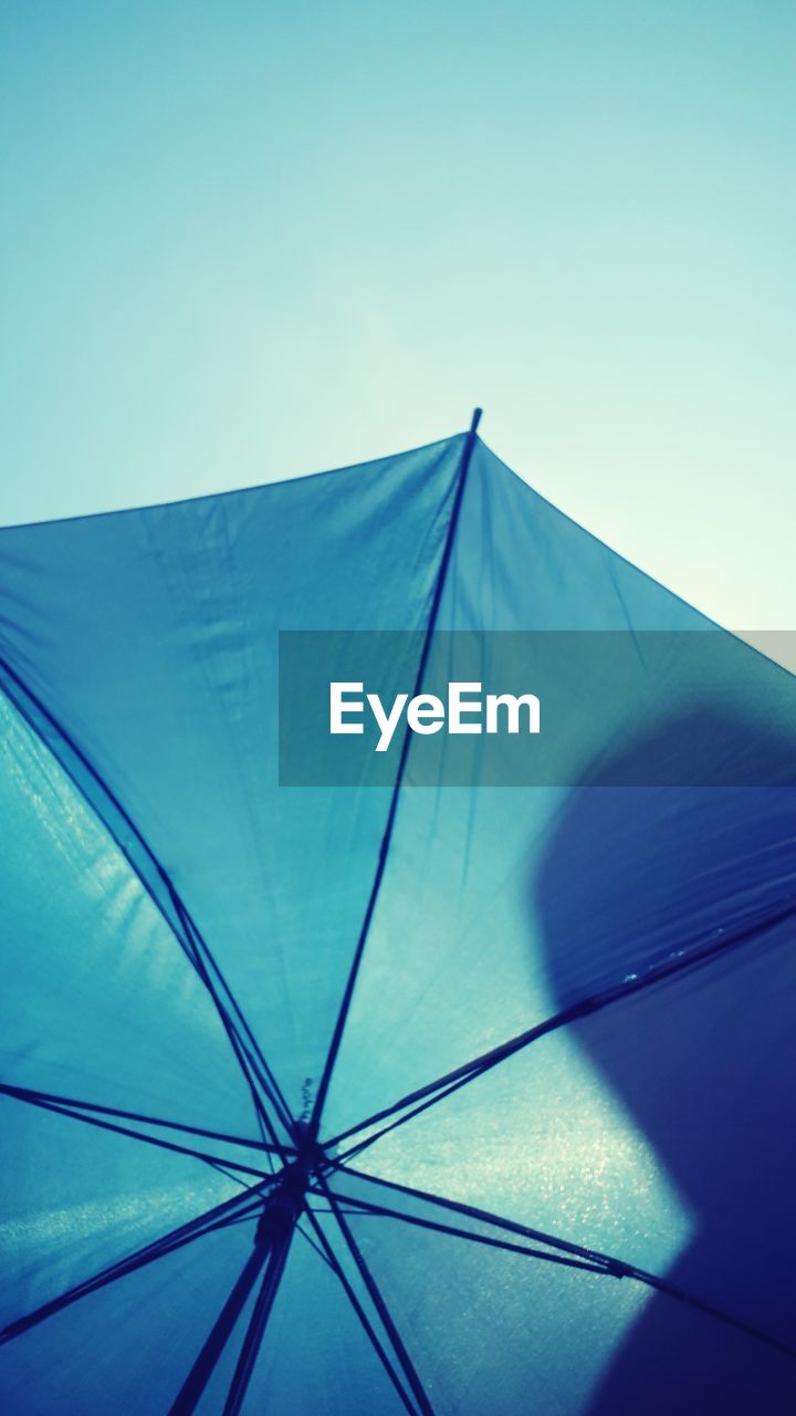 LOW ANGLE VIEW OF UMBRELLA AGAINST CLEAR SKY