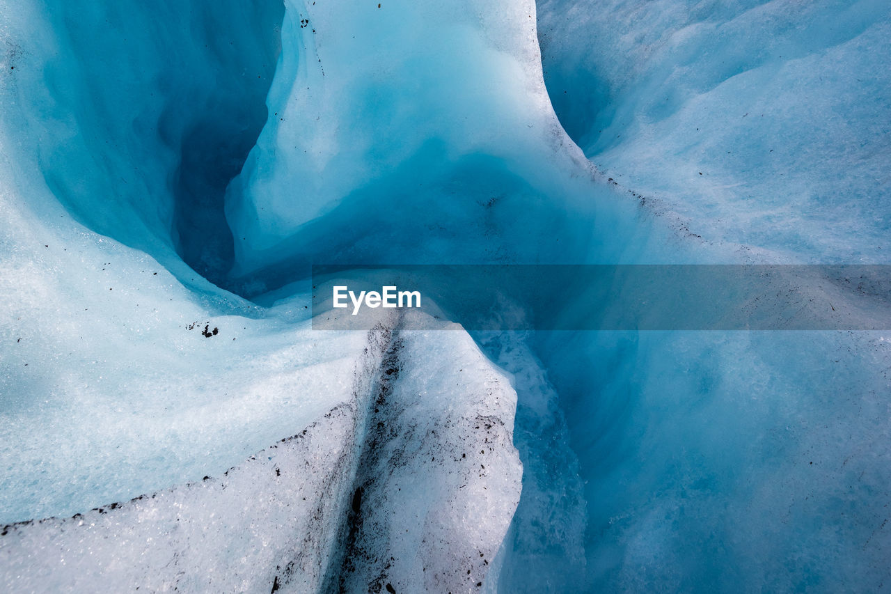 low section of person skiing on snow covered landscape