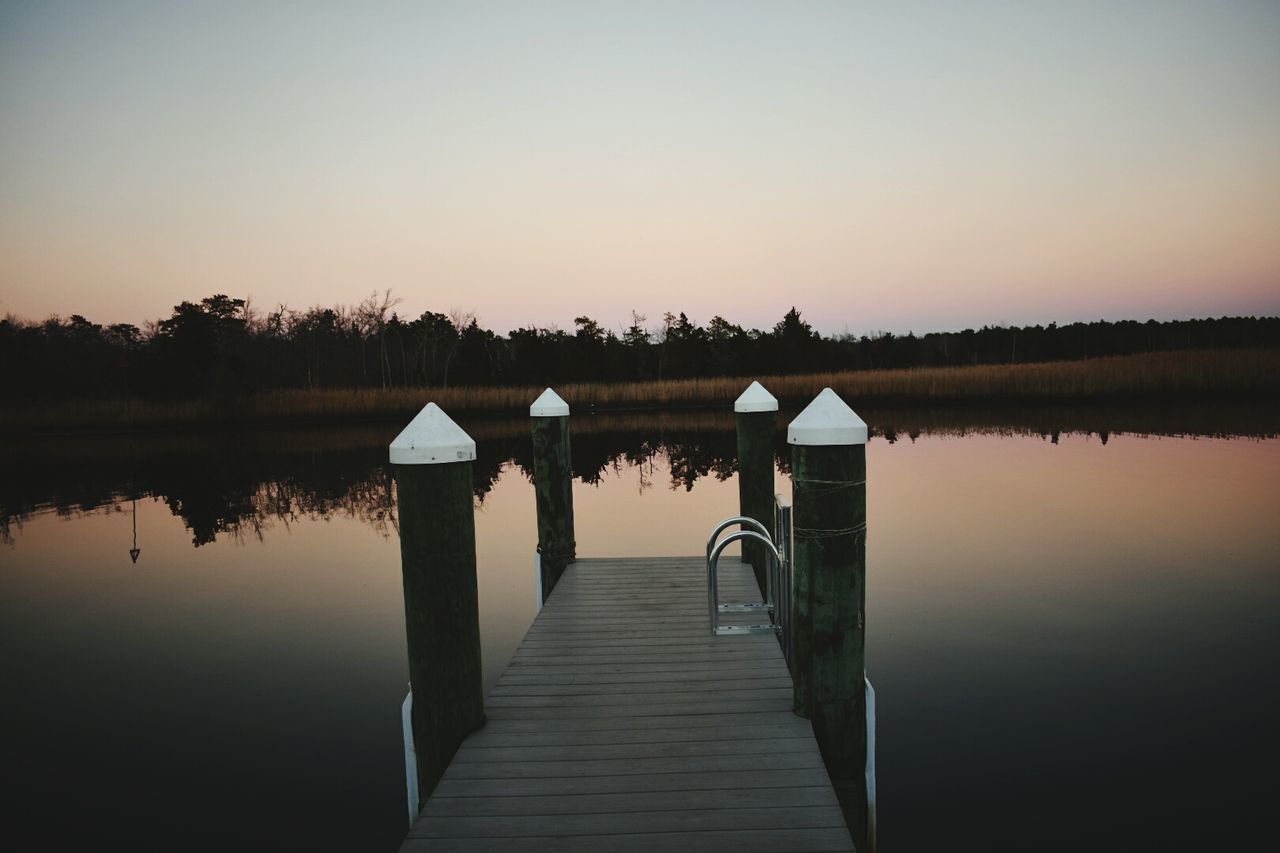 WOODEN PIER ON LAKE AGAINST CLEAR SKY