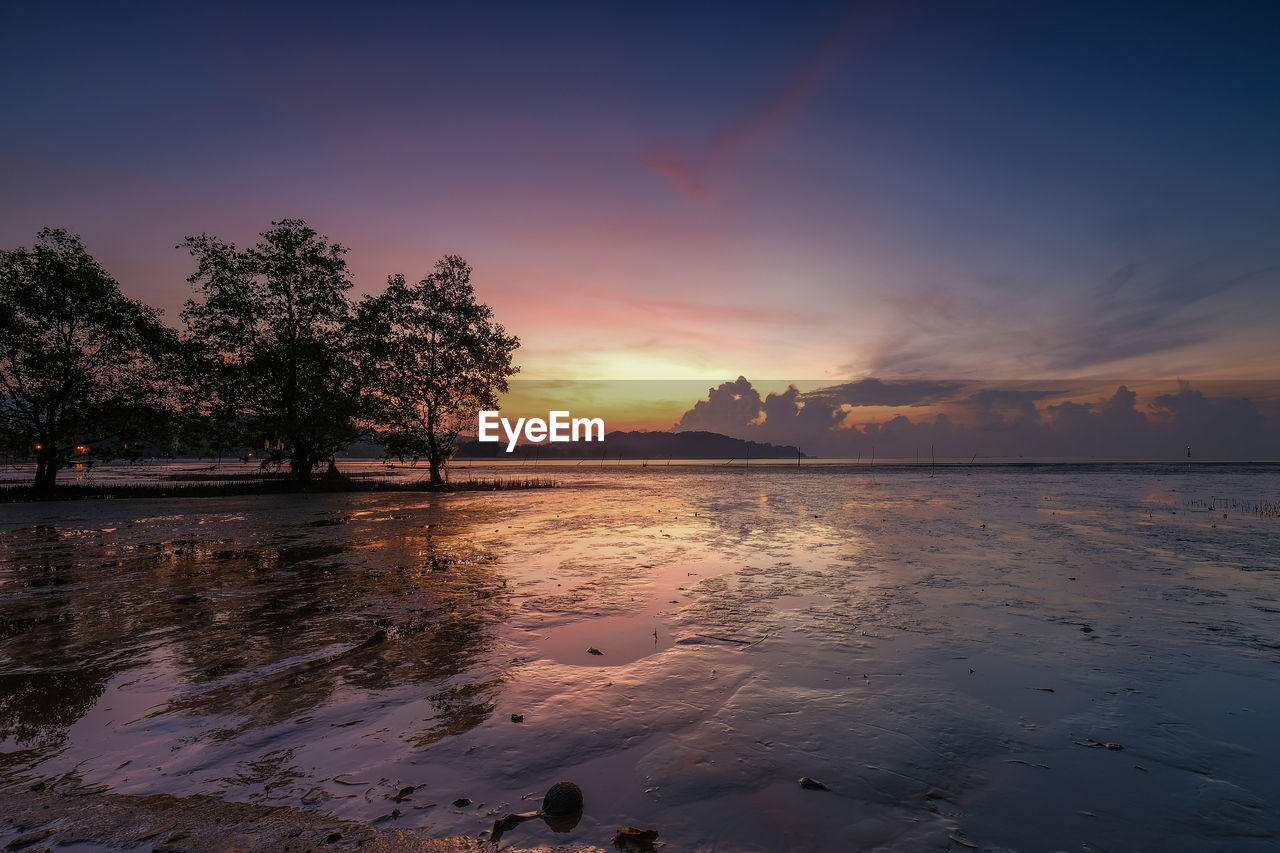 Scenic view of sea against romantic sky at sunset