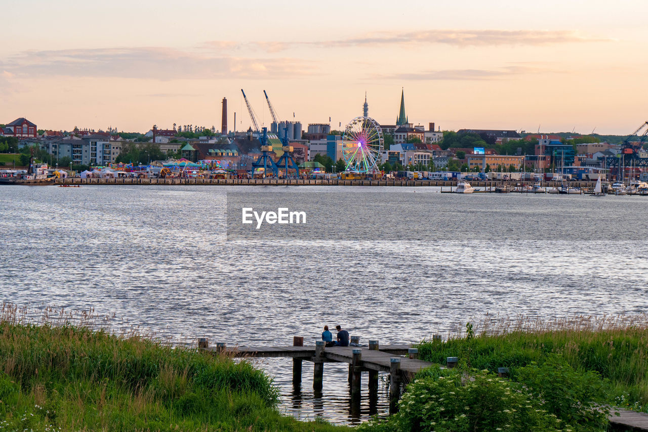 SCENIC VIEW OF RIVER AGAINST BUILDINGS IN CITY