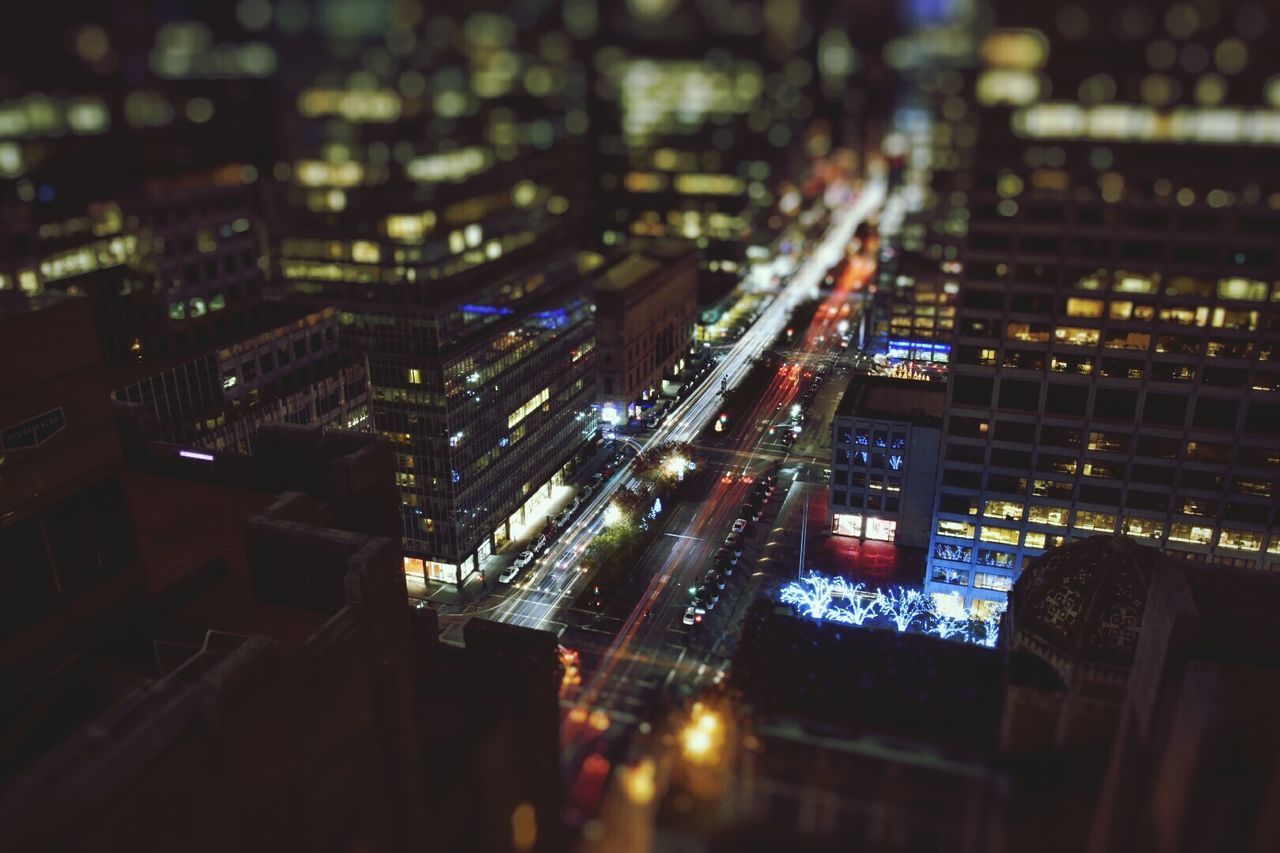 Tilt-shift image of illuminated cityscape at night