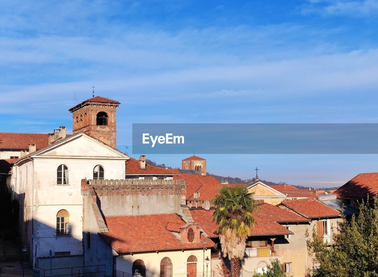 architecture, building exterior, built structure, building, town, sky, place of worship, religion, nature, travel destinations, city, roof, belief, blue, history, house, residential district, tower, the past, no people, travel, spirituality, village, cloud, tourism, day, outdoors, old, vacation, sunlight, tree, roof tile, plant